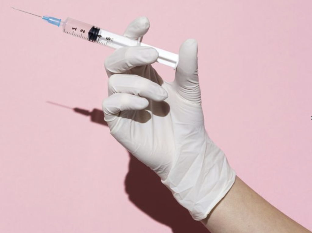 A needle held by a Doctor as that is how semaglutide is administrated to the patient. 